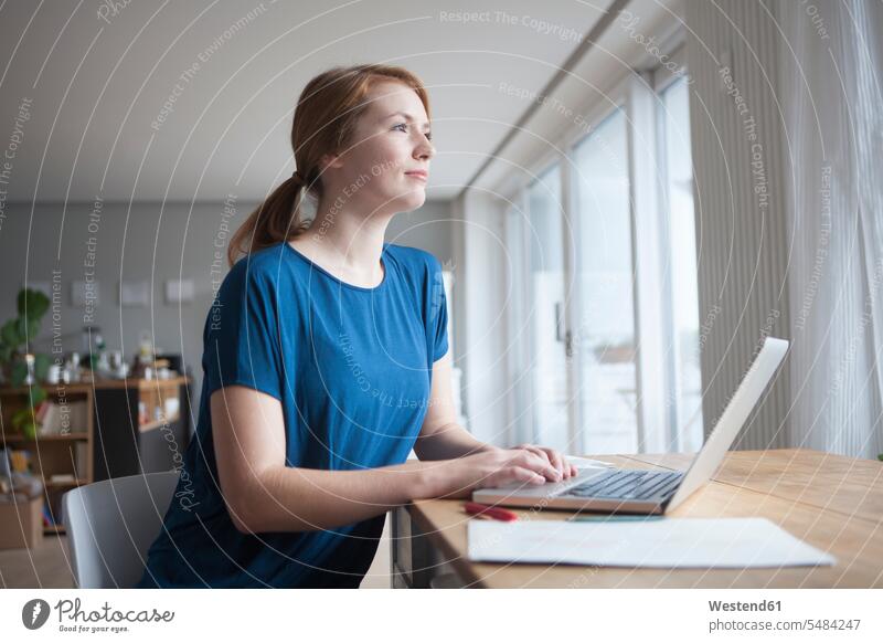 Young woman sitting at table with laptop caucasian caucasian ethnicity caucasian appearance european using laptop using a laptop Using Laptops Wifi Wi-Fi
