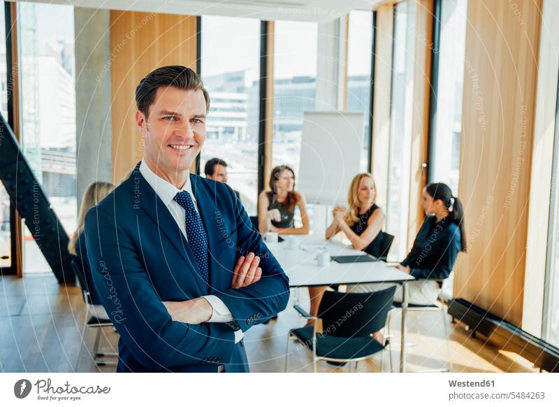Portrait of confident businessman in a meeting arms crossed Arms Folded Folded Arms Crossed Arms Crossing Arms Arms Clasped Medium Group of People businesswoman