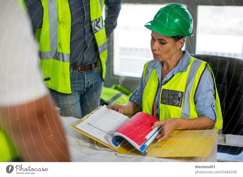 Female quarry worker checking files in office blue collar worker workers blue-collar worker mining discussing discussion working At Work Reliability reliable