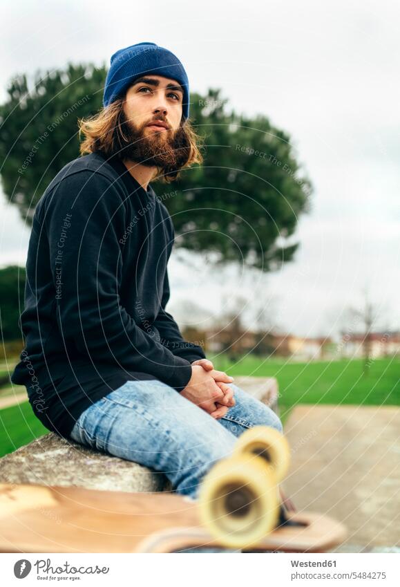 Portrait of bearded young skateboarder caucasian caucasian ethnicity caucasian appearance european sitting Seated leisure free time leisure time