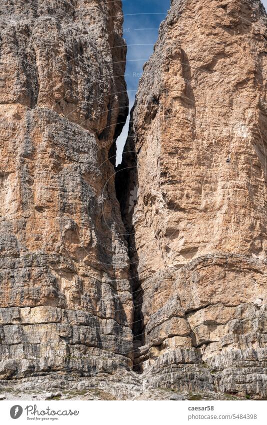 Mountaineers climbing up the 3 Zinnen in the dolomite mountains rock fissure cliff rugged small lonely mountaineer high steep mountaineers two people action