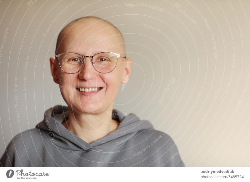 Smiling bald woman in glasses struggle with oncology look at camera. Hairless cancer sick female patient after chemotherapy lost her eyebrows and eyelashes feel optimistic of recovery remission