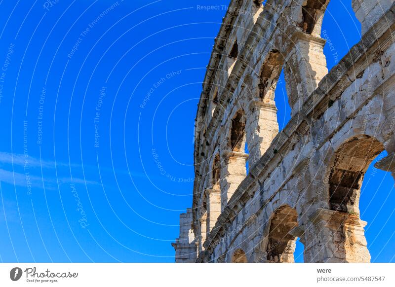 The ruins of the Roman arena in the Croatian city of Pula under a blue sky on a sunny day building copy space historic historical historical building house old