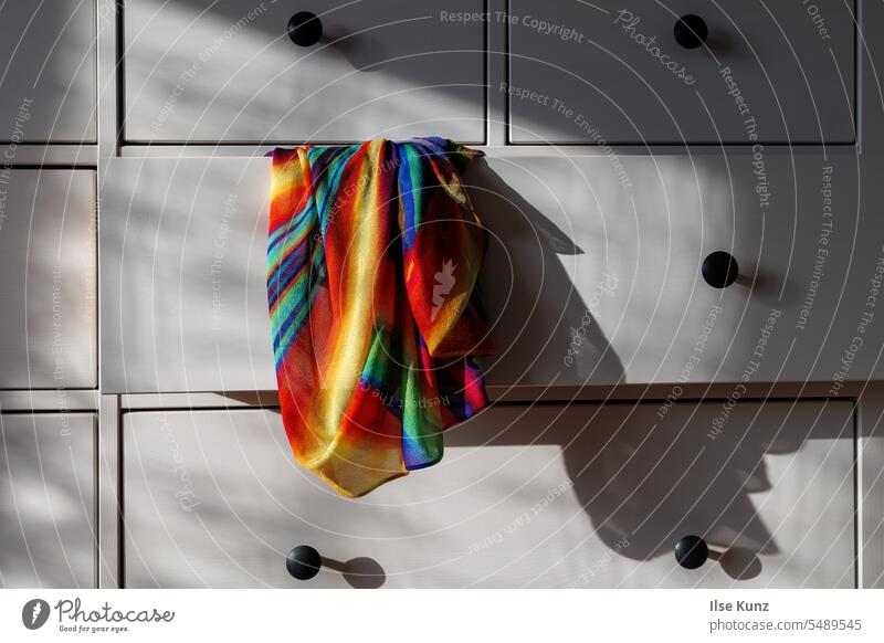 Colorful cloth hangs from open drawer of dresser Rag variegated Chest of drawers Drawers Open Light Shadow Shadow play
