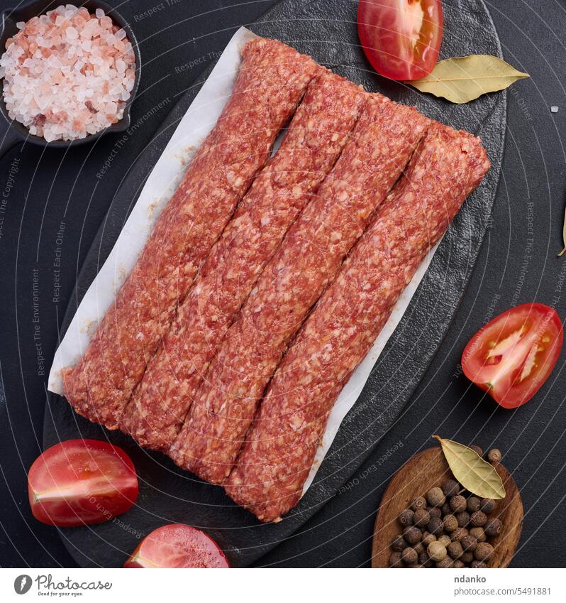 Raw lula kebab sausages on a board and spices, top view grill meat traditional cuisine fresh food barbecue lamb beef raw meal dinner bbq uncooked lunch dish