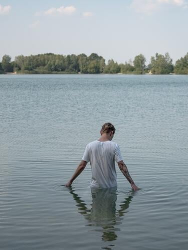 Man standing in water Lake Water Nature Exterior shot Reflection Deserted