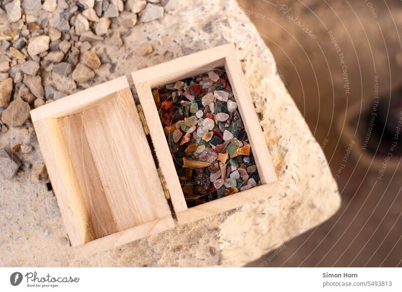 Mineral resources lie in a small wooden box treasures of the soil findings variegated gemstones Seldom Treasure Chest valuable ideal Estimation amass Playing