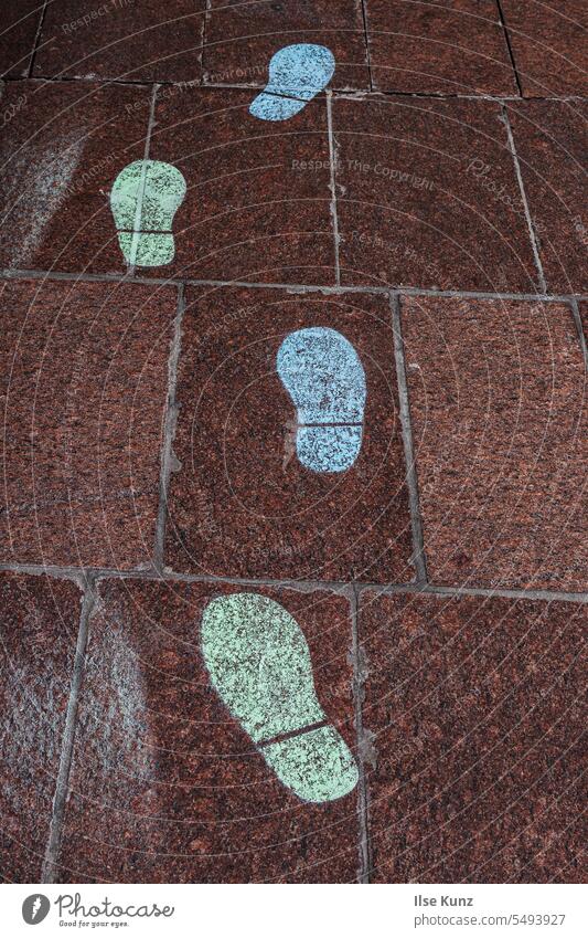 Green and blue footprints on paving stones Footprint Blue Tracks downtown stone tiles Stone floor Paving stone