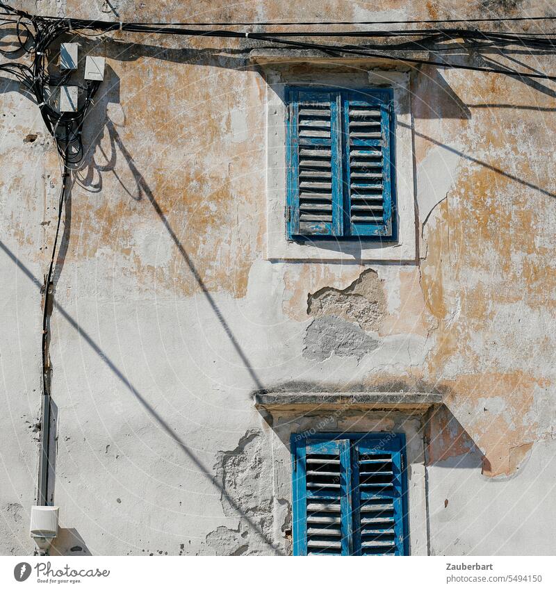 Wires, shutters and an old facade with peeling plaster in Croatia Cables Plaster Leafing through Shadow morbid romantic Open Shutter Window