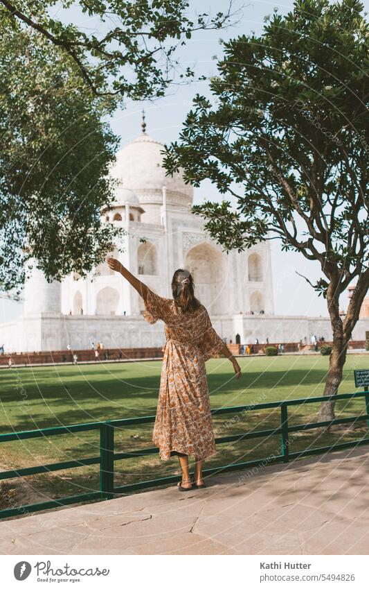 young women stands before the Taj Mahal in a long dress India travel Travel photography traveler Agra Tourist Attraction touristic Vacation & Travel Asia
