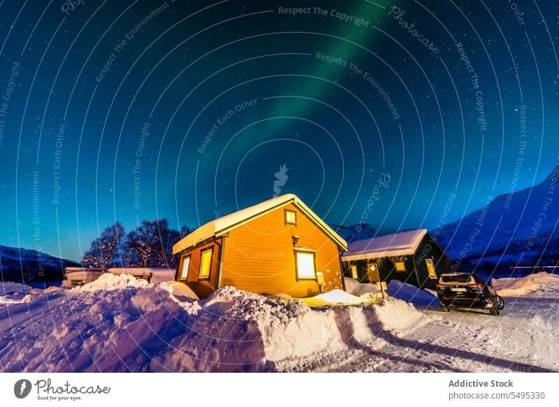 Cabins against northern lights in winter house cabin aurora borealis picturesque night snow rooftop norway lapland lofoten island europe atlantic nordic arctic