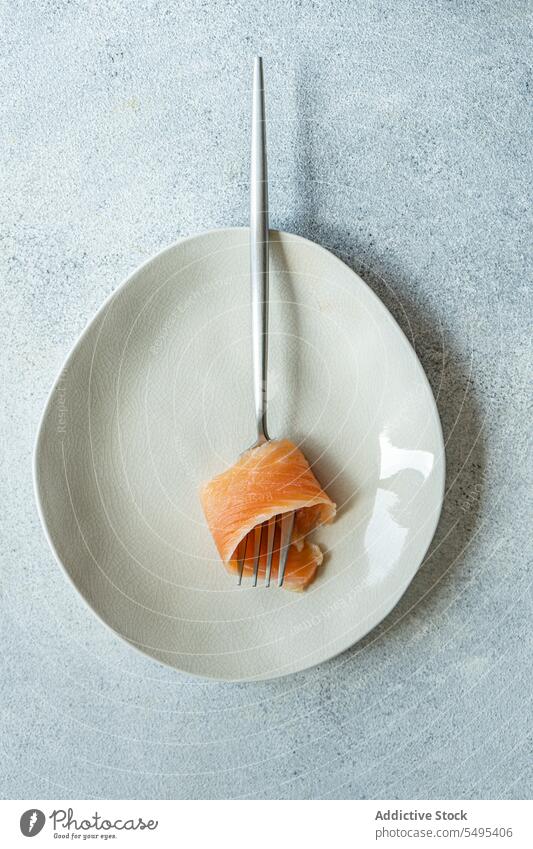 Healthy salmon slice on white plate dish healthy food table surface yummy fresh nutrition nutrient fork menu high angle from above top view fish diet meal