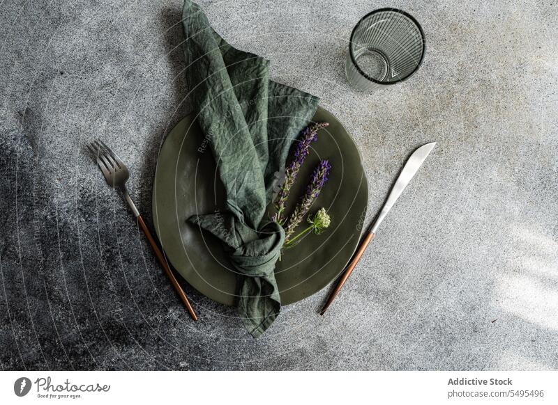 Table setting with flowers table decoration knife fork napkin cloth lavender glass transparent empty green autumnal plate dish fall seasonal surface gray