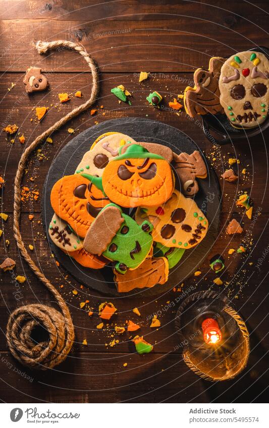 Delicious Halloween cookies on wooden table halloween plate tasty treat rope delicious holiday yummy baked pastry food celebrate homemade biscuit october snack