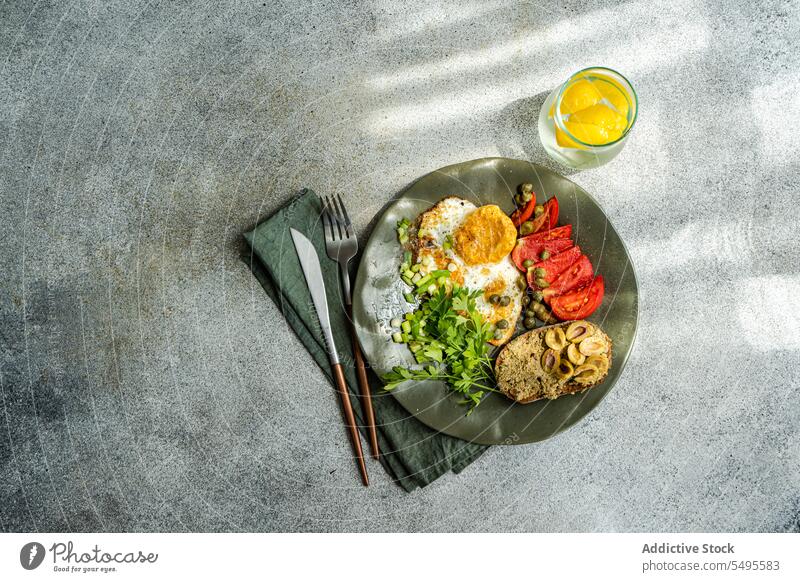 Healthy lunch with fried eggs and tomatoes slices plate fresh healthy food natural dish appetizing culinary brunch diet vegetarian napkin ingredient vegetable