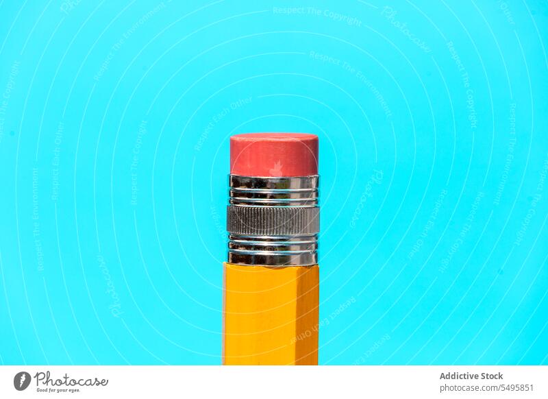 Bright yellow pencil with eraser on top in blue studio rubber bright education object background stationery wooden concept school color vivid red creative