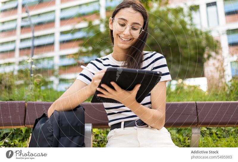 Young woman using tablet on street write happy smile modern city female gadget device glasses young contemporary positive connection glad digital joy town