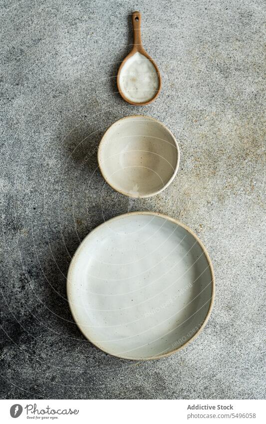 Ceramic tableware set on gray table ceramic bowl plate spoon wooden gray background high angle from above crop dish empty clean object dishware nobody design