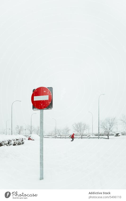 No entry sing in snow near road warning no entry signpost stop winter control regulation notice rule signal traffic prohibit restriction safety wintertime