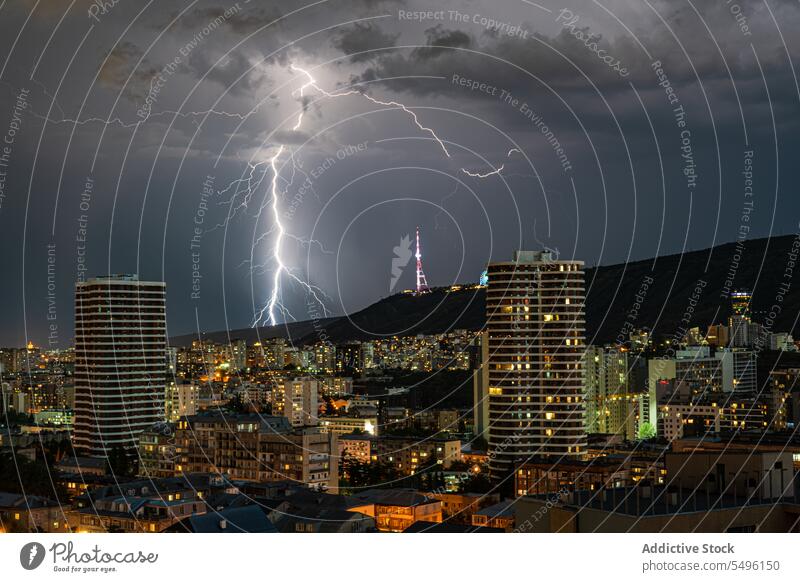 Dramatic sky with lightnings in the night over Tbilisi's downtown dramatic dark darkness storm stormy tbilisi's building house weather city outdoors landscape