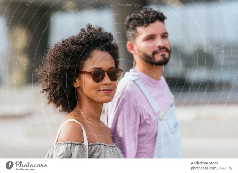 Content young couple in casual outfit on street happy smile relationship bonding glad curly hair hairstyle girlfriend date positive optimist pleasure pleasant