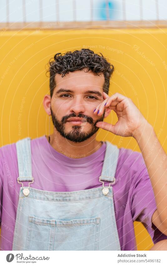 Young bearded man looking at camera against yellow background touch confident touch face positive sad upset apron stress displease human face mood alone worried