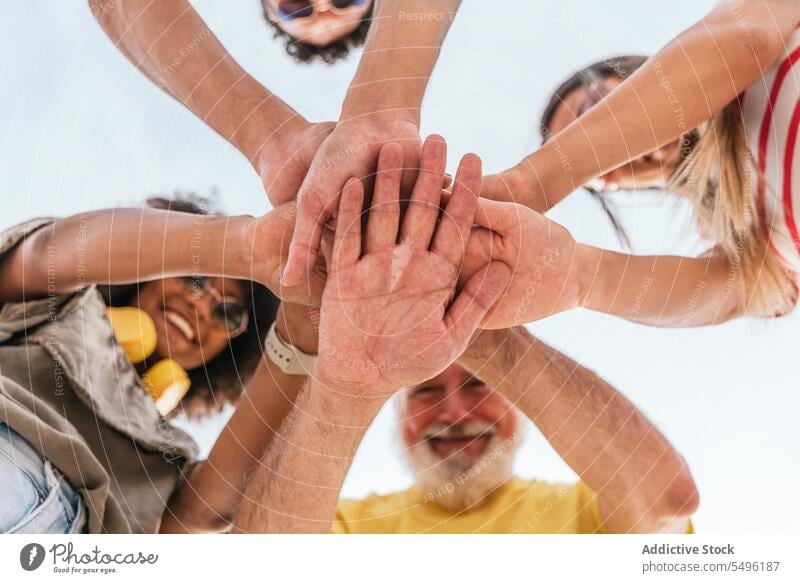 Group of crop people stacking hands outside friend friendship happy together cheerful fun smile stack hands unity positive cooperate having fun group laugh team