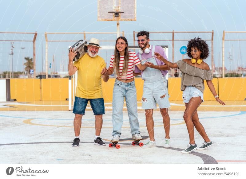 Happy diverse friends with skateboard and radio and dancing happy smile dance music fun listen earphones group energy glad positive optimist having fun sound