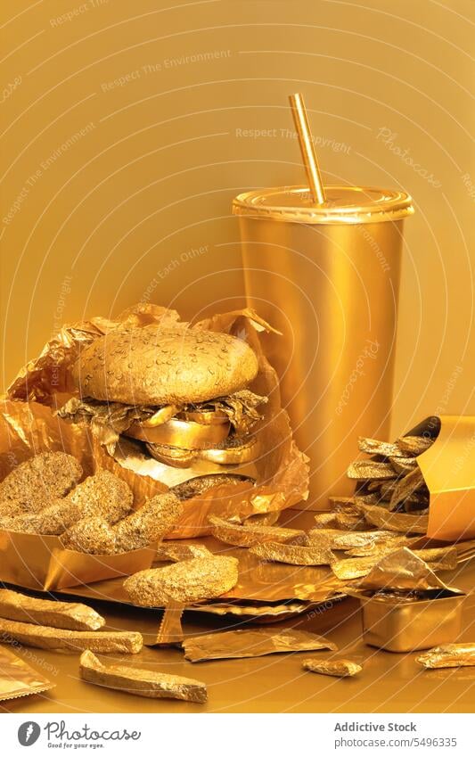 Street Food in a gold colored packaging street food hamburger fried potatoes disposable colors product photography scene studio shot light delicious tasty