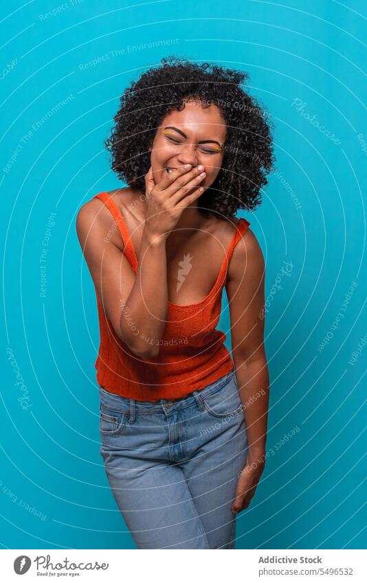 Cheerful black woman with curly hair smiling model afro hairstyle cheerful excited smile laugh joke female african american humor having fun expressive reaction