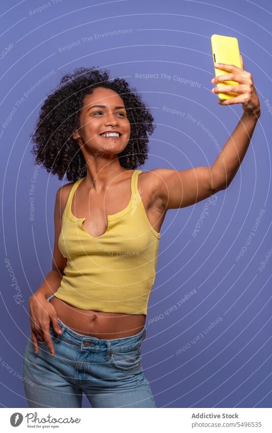Cheerful ethnic woman taking selfie on cellphone smartphone using trendy positive smile leisure carefree happy self portrait style cheerful female mobile gadget