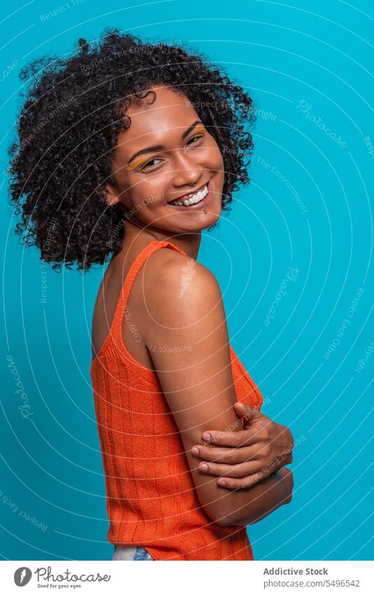 Optimistic black woman with Afro hairdo fashion model afro curly hair friendly optimist smile portrait female african american charismatic candid sincere
