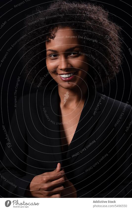 Smiling ethnic woman in elegant suit in studio smile positive outfit happy model glad delight appearance hispanic young female cheerful optimist trendy lady