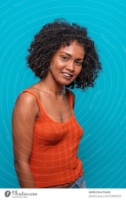 Optimistic black woman with Afro hairdo fashion model afro curly hair friendly optimist smile portrait female african american charismatic candid sincere