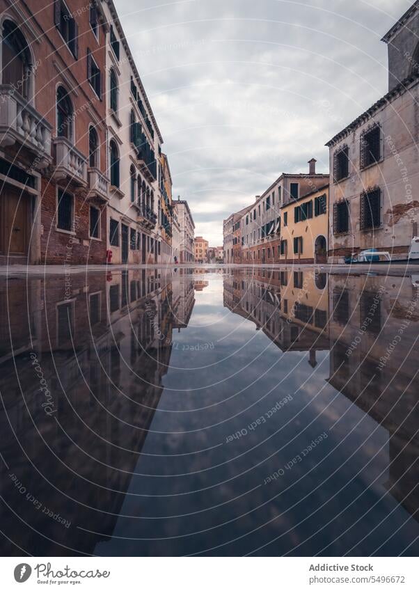 Exterior of old city reflecting in flooding water street building high water narrow gloomy exterior facade venice italy europe tourism travel trip vacation