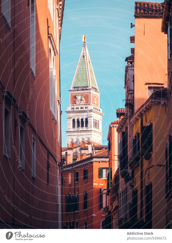 Medieval bell tower and old buildings on narrow street architecture facade city heritage historic residential aged ancient blue sky culture st marks campanile