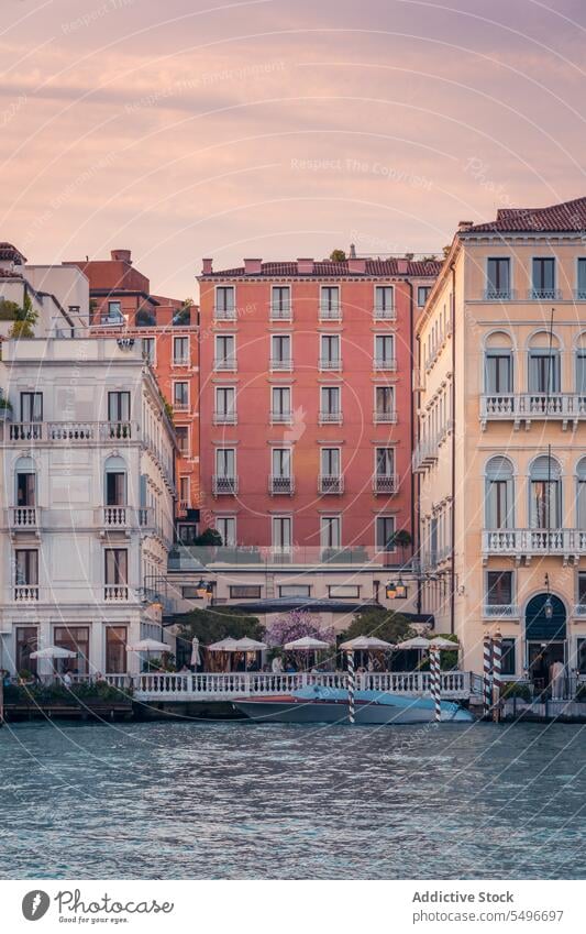 Facades of houses with windows and pathway on street in Venice city old building exterior facade canal boat venice italy europe tourism travel trip vacation