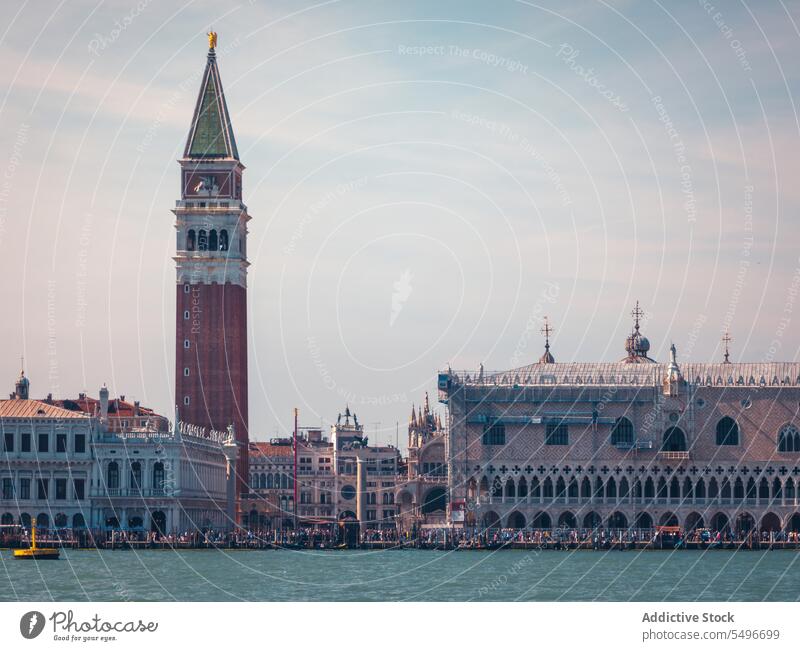 Channel water near historic buildings in sunlight architecture basilica canal sightseeing landmark culture city float sunset tower church venice italy scenic