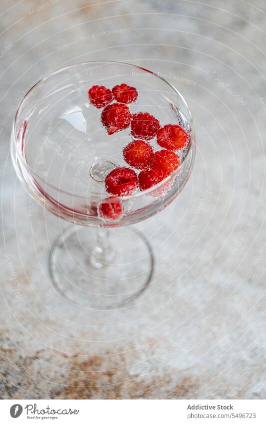 Glass of champagne and raspberry cocktail against blurred background fresh glass drink alcohol refreshment serve beverage ripe table cold vitamin delicious