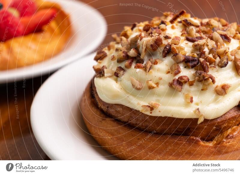 Delicious cake with cream and nuts on plate over wooden table delicious sweet dessert homemade pastry food piece tasty yummy baked kitchen appetizing culinary