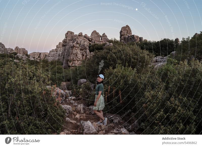 Cheerful woman admiring view of mountains traveler admire el torcal de antequera rocky magnificent landscape cheerful sunset female asian sierra del torcal