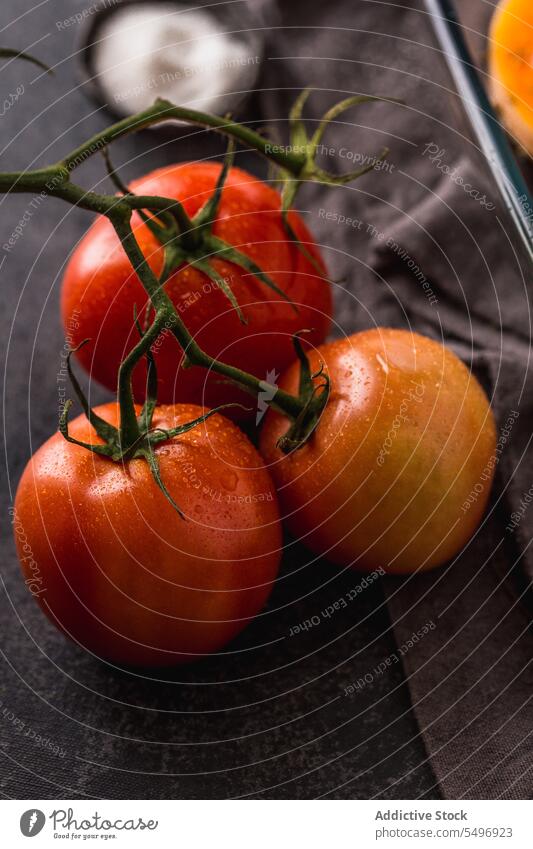 Ripe tomatoes in stalk placed on table fresh ripe natural whole raw vitamin organic vegetable healthy ingredient vegetarian healthy food stem nutrition product
