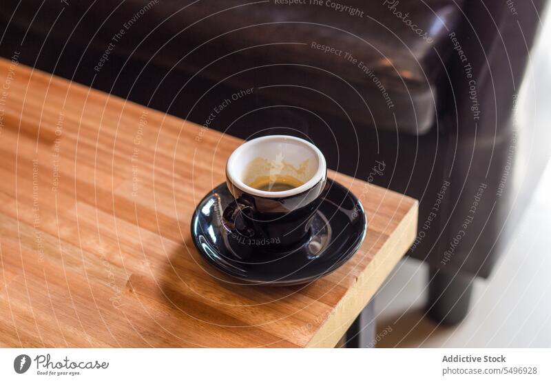 Cup of coffee on saucer over wooden table cup espresso aromatic drink beverage hot drink fresh tasty morning breakfast caffeine delicious brew ceramic black