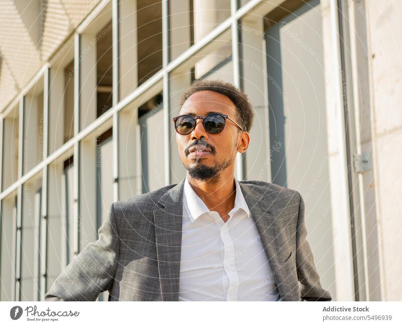 Pensive black businessman admiring spectacular cityscape entrepreneur style suit admire pensive think downtown sunglasses male african american executive