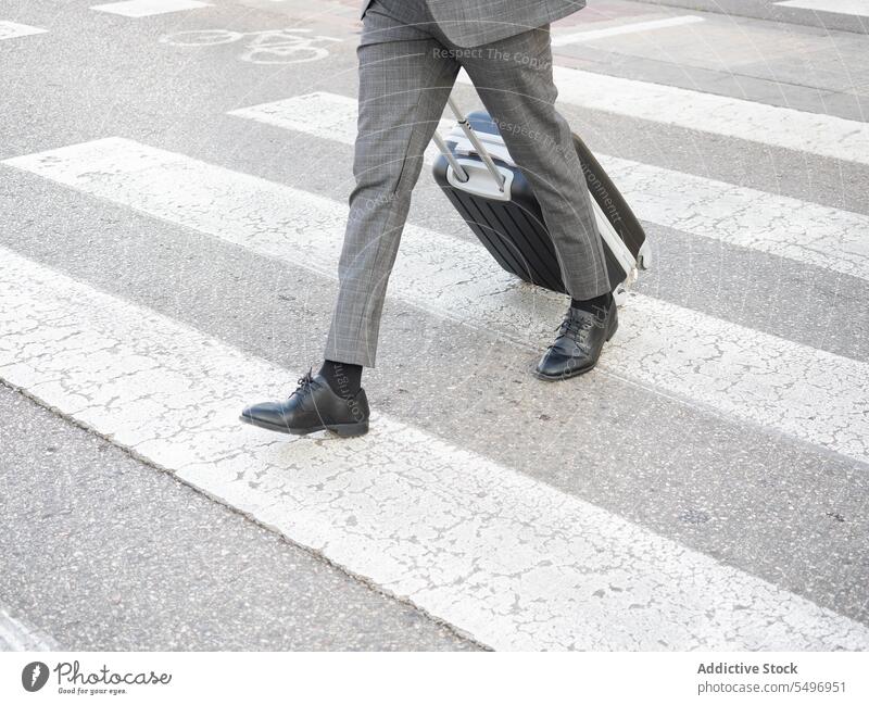 Black man with suitcase on crosswalk pedestrian travel bag backpack zebra roll male black african american entrepreneur citizen luggage baggage belonging