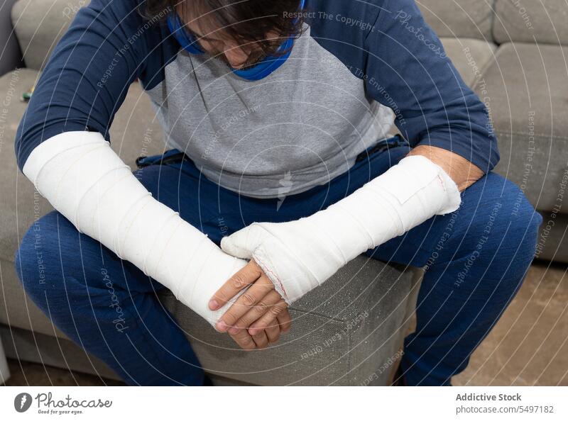 Man with casts having pain man patient struggle broken arm emergency hospital frustrate male orthopedic bandage physical trauma injury fracture ache sore suffer