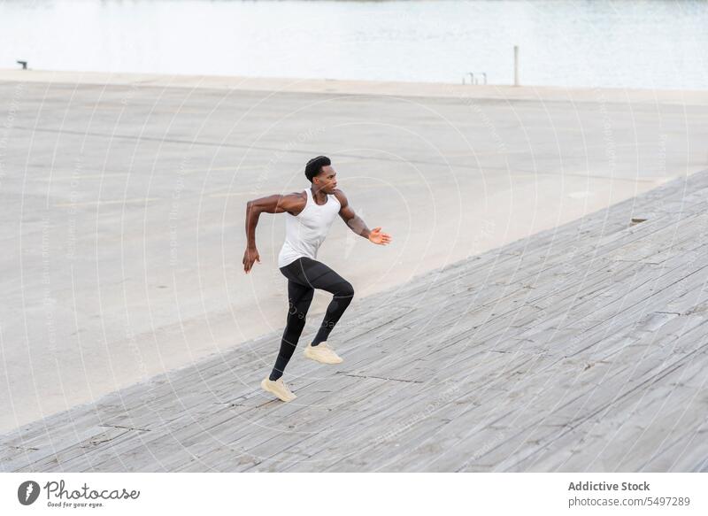 Black sportsman training on stairs athlete exercise jog sportswear workout practice cityscape male black african american model run cardio aerobic fitness