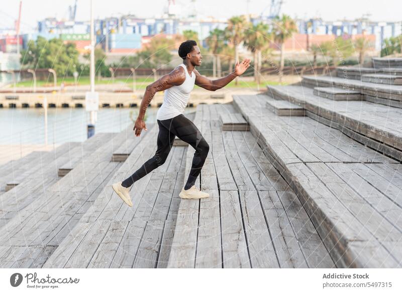 Black sportsman training on stairs athlete exercise jog sportswear workout practice cityscape male black african american model run cardio aerobic fitness