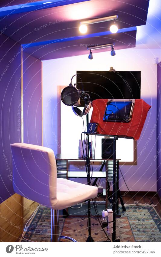Interior of recording studio room with chair and microphone equipment in lights desk interior design gadget creative tablet podcast style workplace professional