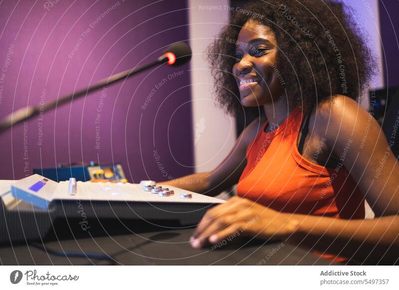 Happy black woman recording sound audio engineer music studio mix create female african american technician composer production industry radio dj equalizer